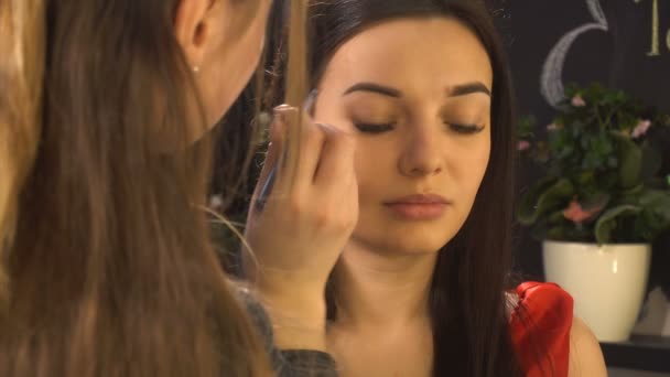 Makeupartist gör makeup för kvinna modell — Stockvideo
