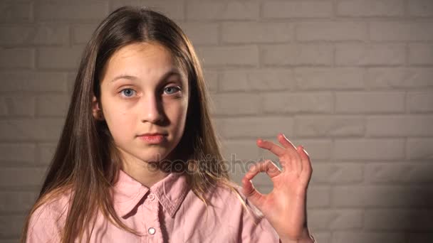 Дівчина-підліток показує, що все гаразд — стокове відео