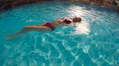 Ağır çekimde sırt üstü sualtı Yüzme kadın