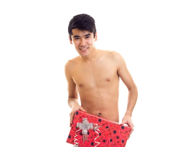 Undressed young man holding present — Stock Photo, Image