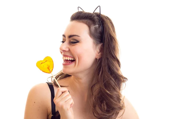 Young woman in black bra with candy — Stock Photo, Image
