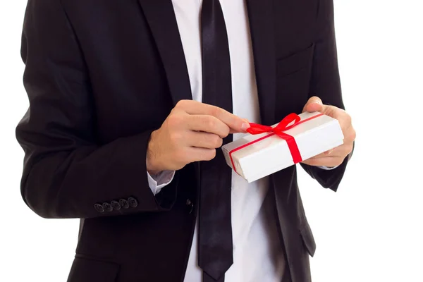 Young man in suit holding a present — Stock Photo, Image