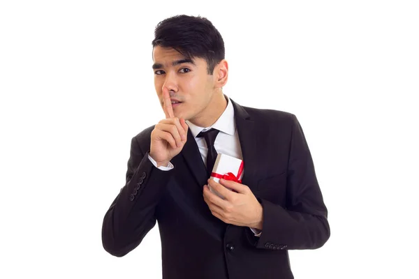 Young man in suit holding a present — Stock Photo, Image
