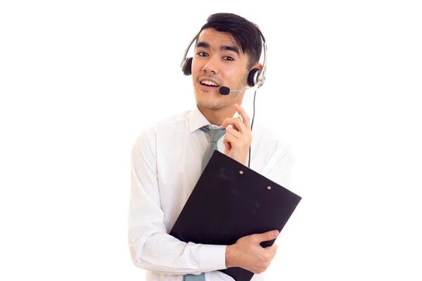 Young man in headphones holding a folder — Stock Photo, Image