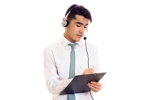 Young man in headphones holding a folder — Stock Photo, Image