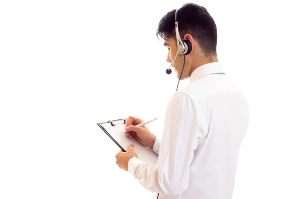 Young man in headphones holding a folder — Stock Photo, Image