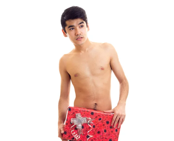 Undressed young man holding present — Stock Photo, Image