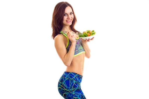 Sportieve vrouw bedrijf salade — Stockfoto