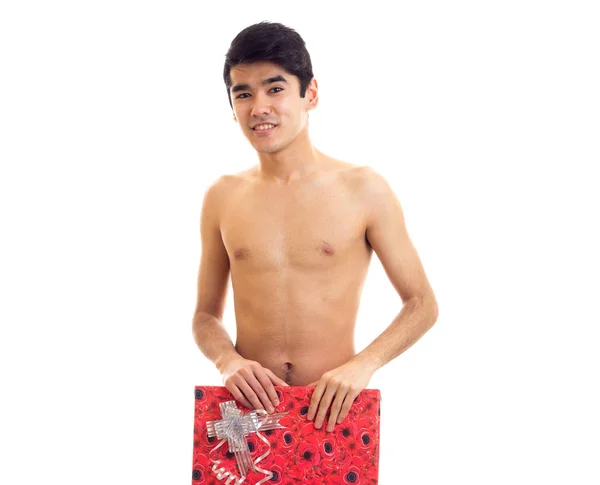 Undressed young man holding present — Stock Photo, Image