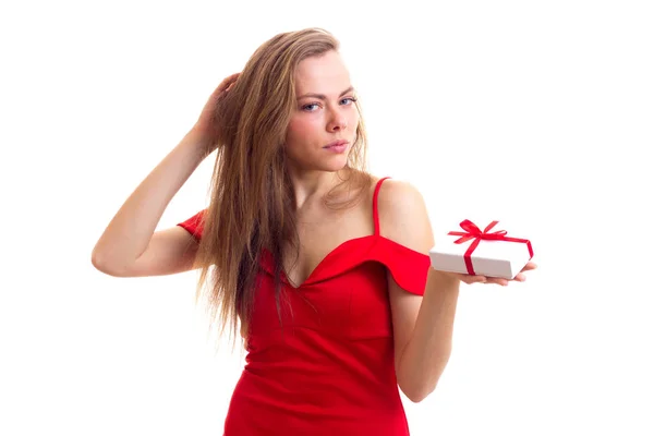 Young woman in red dress holding present — Stock Photo, Image