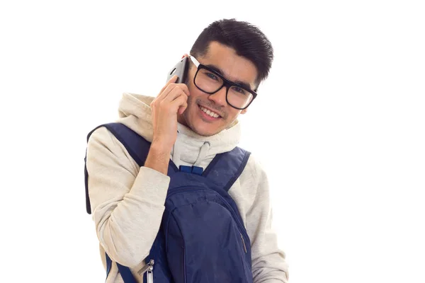 Young man with glasses, smartphone and backpack — Stock Photo, Image