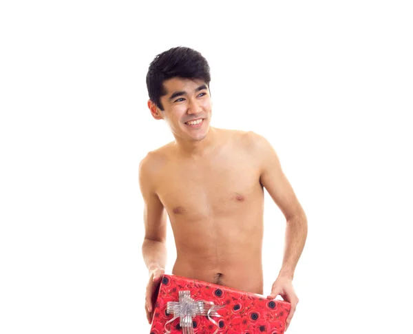 Undressed young man holding present — Stock Photo, Image