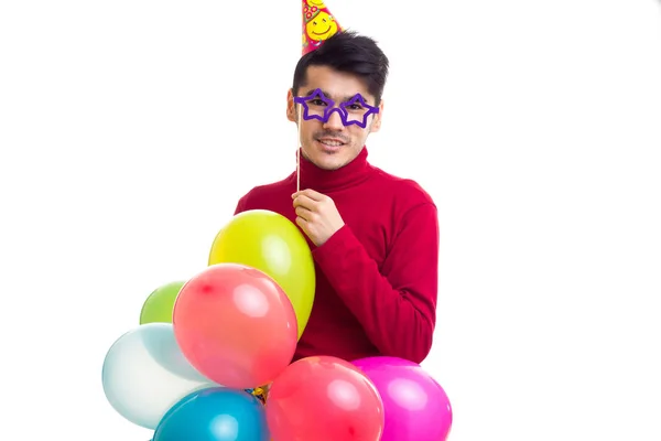 Young man holding balloons — Stock Photo, Image