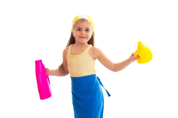 Girl in apron holding two bottles — Stock Photo, Image