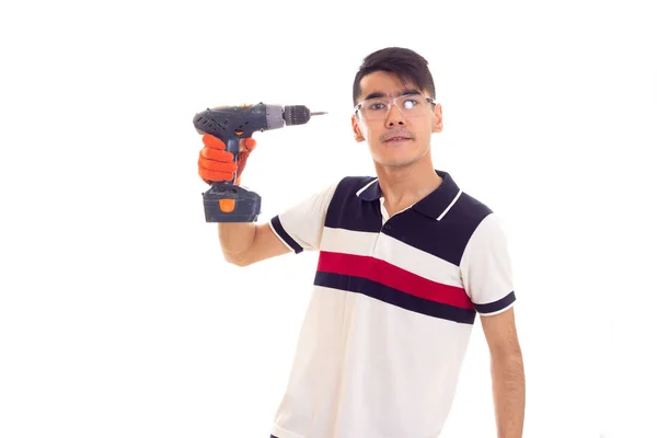 Young man with gloves and glasses holding electric screwdriver — Stock Photo, Image