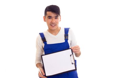 Mavili genç adam elinde kalem ve klasör tutuyor.