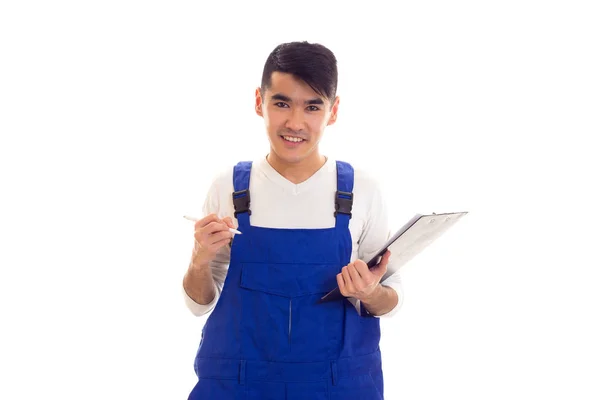 Молодий чоловік в блакитному в цілому тримає ручку і теку — стокове фото