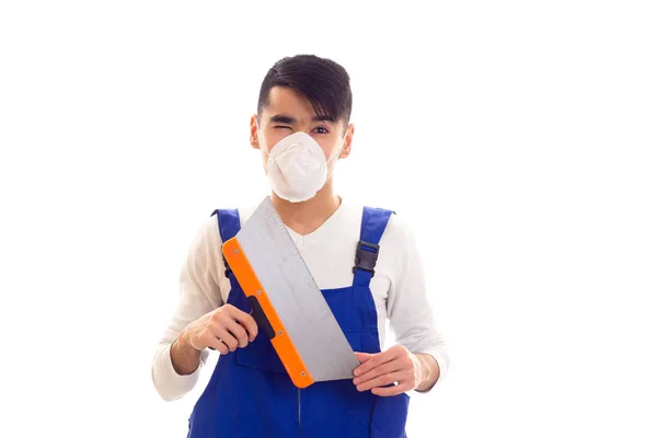 Man in blue overall with respirator holding spatula — Stock Photo, Image