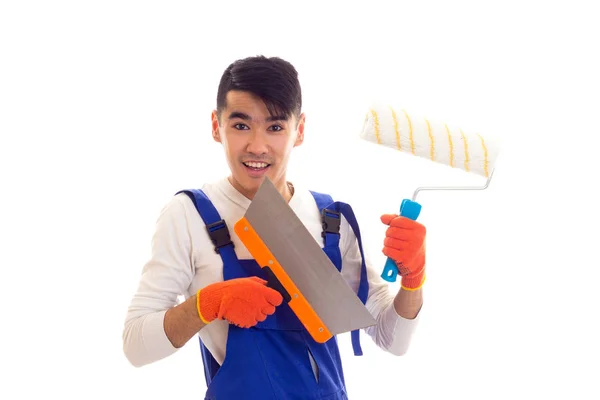 Man in blue overall with gloves holding spatula and roll Royalty Free Stock Photos