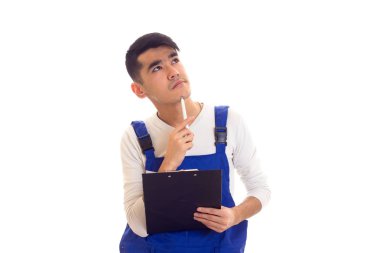 Mavili genç adam elinde kalem ve klasör tutuyor.