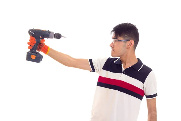 Jonge man met handschoenen en bril houden van elektrische schroevendraaier — Stockfoto