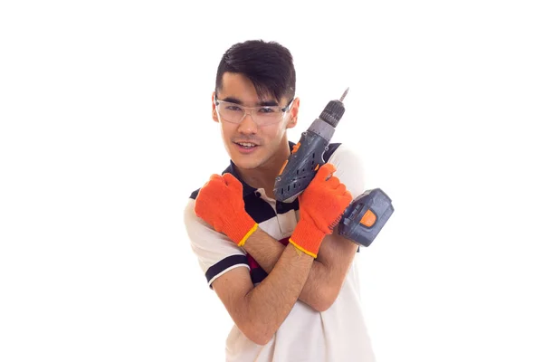 Young man with gloves and glasses holding electric screwdriver — Stock Photo, Image