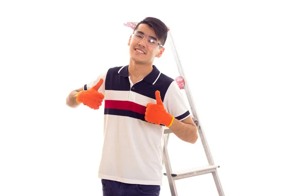Young man with electric screwdriver and ledder — Stock Photo, Image