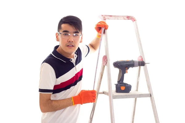 Jonge man met elektrische schroevendraaier en ledder — Stockfoto