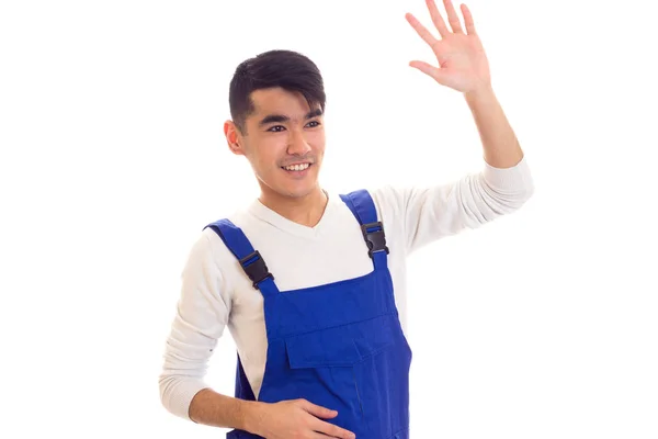 Jonge man in blauwe algemene zwaaien — Stockfoto