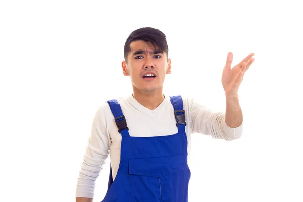 Young angry man in blue overall — Stock Photo, Image
