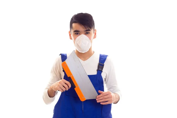 Man in blue overall with respirator holding spatula — Stock Photo, Image