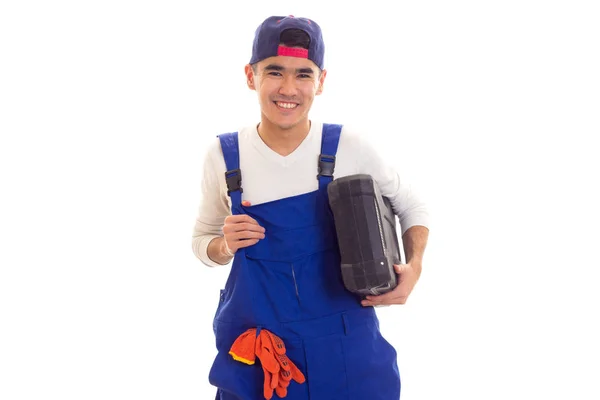 Young man in overall holding toolbox — Stock Photo, Image