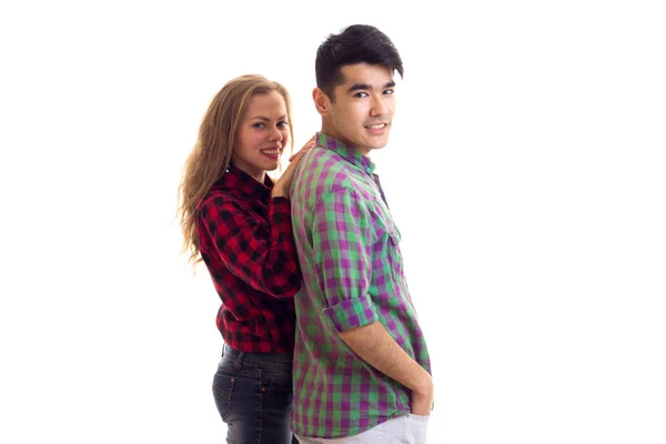 Young couple in plaid shirts hugging — Stock Photo, Image