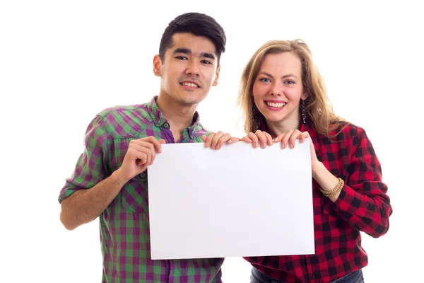 Pareja joven en camisas a cuadros con pancarta —  Fotos de Stock