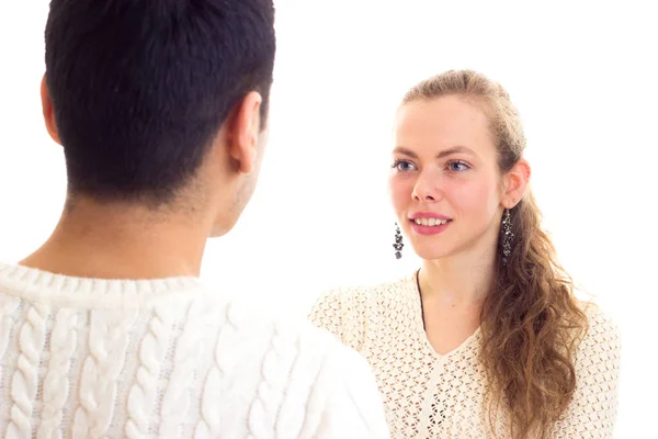 Young couple in white sweaters talking — Stock Photo, Image