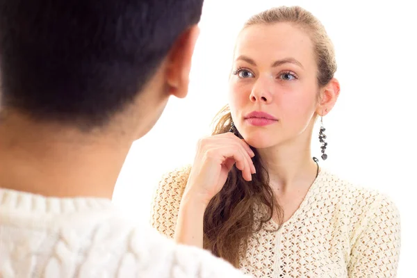 Young couple in white sweaters talking — Stock Photo, Image