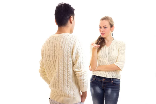 Young couple in white sweaters talking — Stock Photo, Image