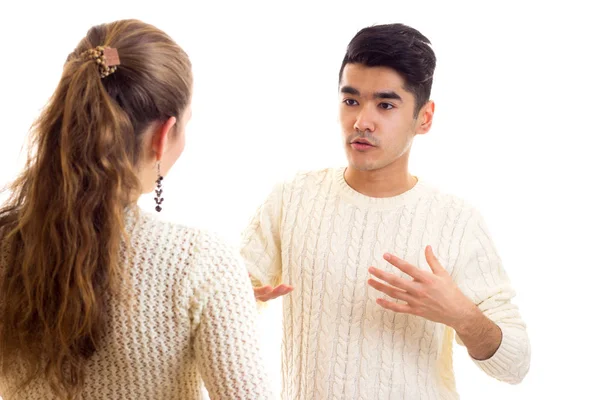 Young couple in white sweaters talking — Stock Photo, Image