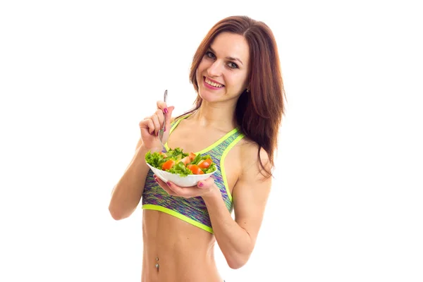 Sportive woman holding salad — Stock Photo, Image