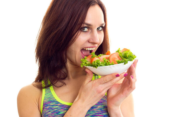 Sportive woman holding salad