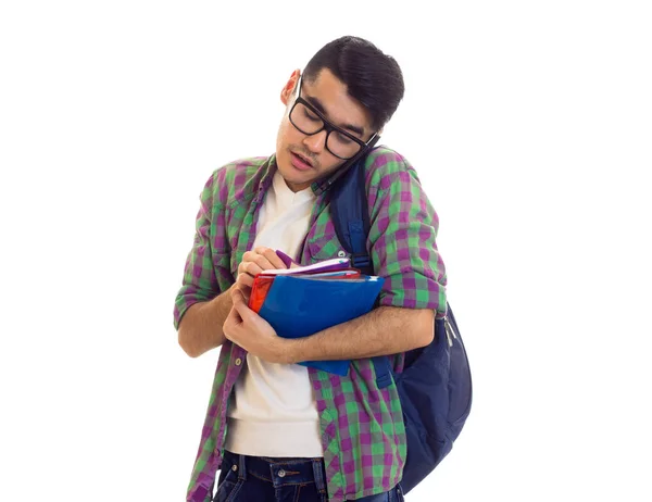 Jovem com mochila, smartphone e livros — Fotografia de Stock