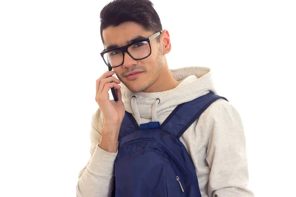 Young man with glasses, smartphone and backpack — Stock Photo, Image