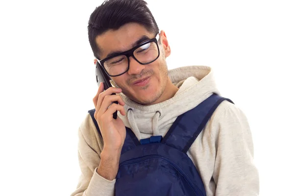 Young man with glasses, smartphone and backpack — Stock Photo, Image