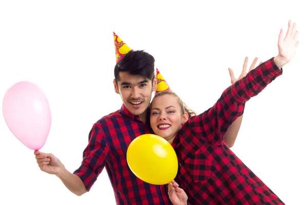 Молодая пара надувает воздушные шары — стоковое фото
