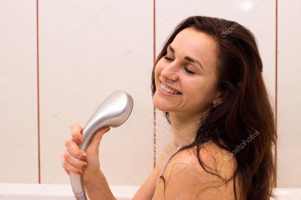 Young woman singing in shower