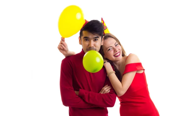 Jovem casal soprando balões — Fotografia de Stock