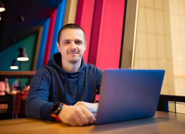Volwassen man freelancer met laptop in cafe — Stockfoto