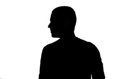 Silhouette of adult back of man looking away in studio clipart
