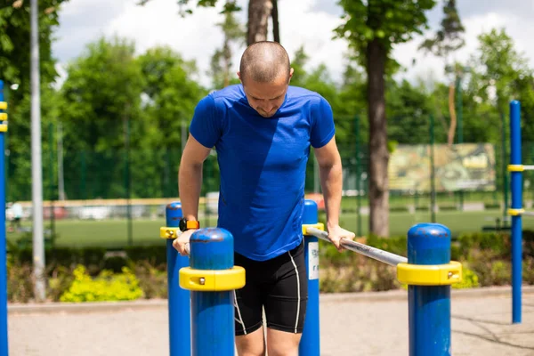 Summer outdoor workout push ups on bars