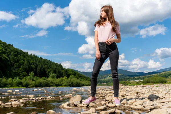 Tini lány pózol álló sziklák közelében Mountain River — Stock Fotó